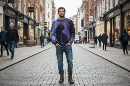Man wearing a sweater with a cat design on a city street