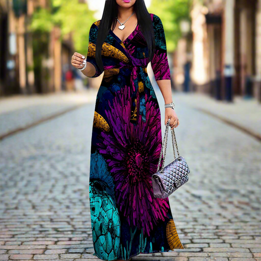Woman wearing a vibrant printed 3/4 sleeve V-neck maxi dress with a detachable belt, walking down a cobblestone street in a city setting.