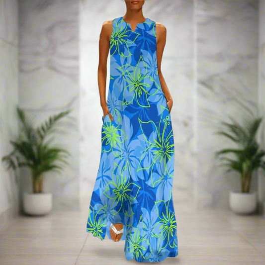 Blue floral-themed sleeveless maxi dress with light and dark flower clusters, worn in a modern bathroom setting.
