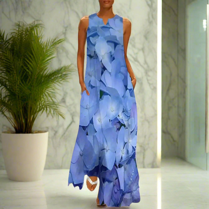 Elegant sleeveless maxi dress featuring a soft blue hydrangea flower print, styled in a marble-finished interior