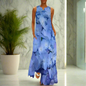 Elegant sleeveless maxi dress featuring a soft blue hydrangea flower print, styled in a marble-finished interior