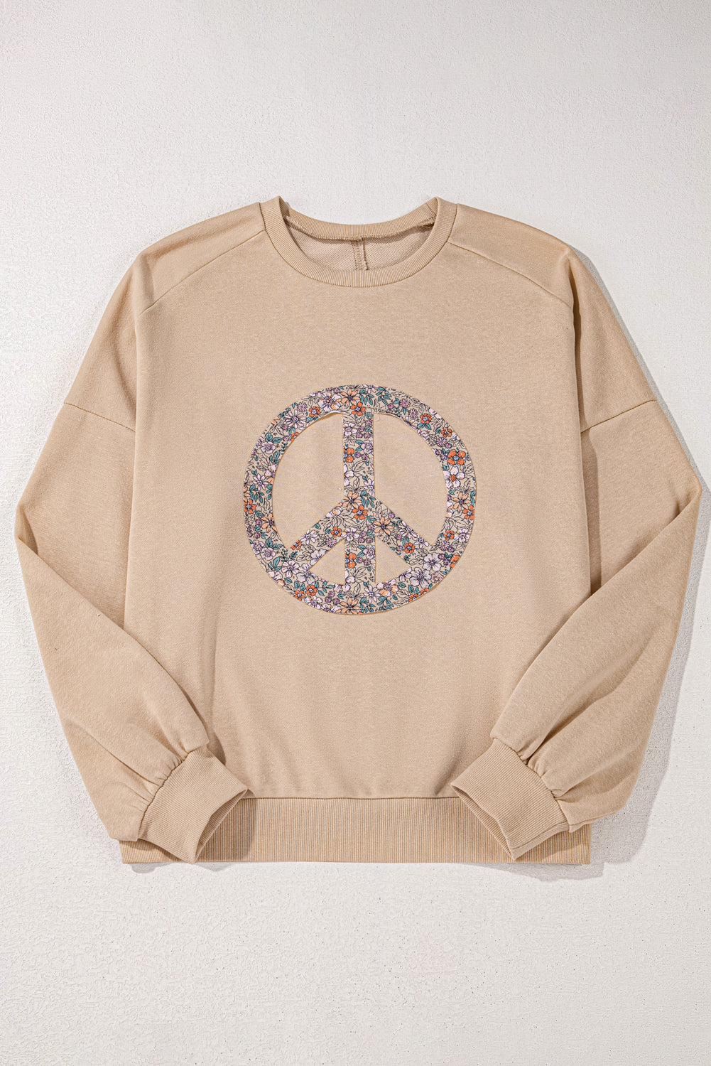 A pale khaki plus-size sweatshirt featuring a floral peace sign graphic and a Washed Terry Finish - ALOE WINGS STORE