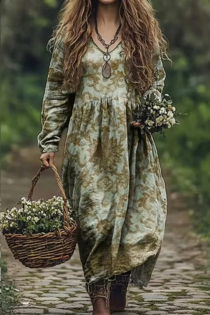 Person wearing a long, patterned dress holding flowers and a basket in a natural setting.