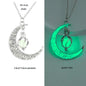 Crescent moon necklace with pendant glowing green on a gray background