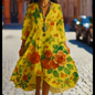 Vibrant yellow floral print dress with butterfly sleeves and flowing skirt, perfect for summer days.