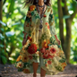 Women’s cream-colored floral dress with full sleeves and irregular hem, worn in a lush green garden setting.