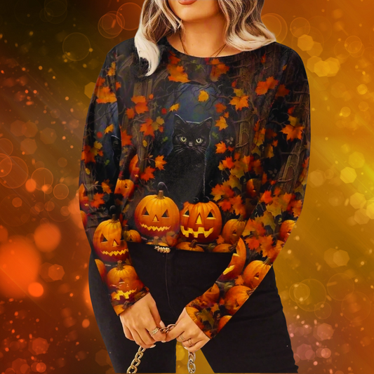 Woman wearing a black and white Halloween sweatshirt featuring a witch flying over a full moon with silhouetted trees and bats – festive and spooky design.