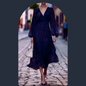 ​Dark blue knee-length dress with subtle pattern and elegant neckline